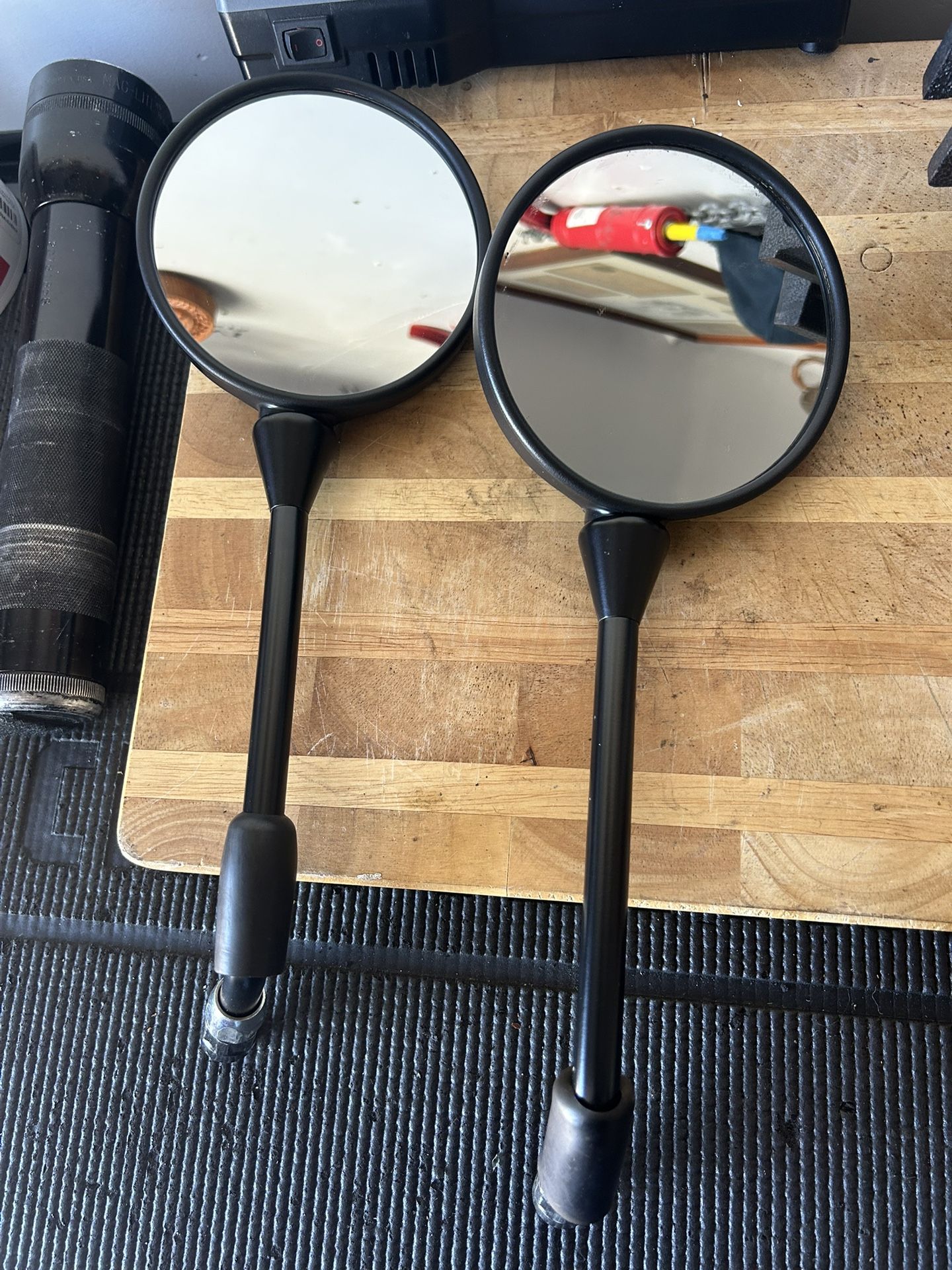 Motorcycle mirrors, two sets of hand grips, and barn weights. All items brand new.