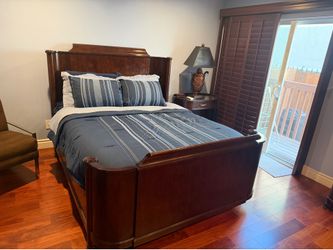 Queen bed, night stand, and lamp
