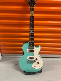 Teal Electric Guitar with White Pickguard