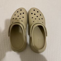 Beige Crocs.