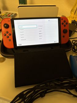 Nintendo Switch OLED w/ Mario Red Joycons And Blue Joycon Grip
