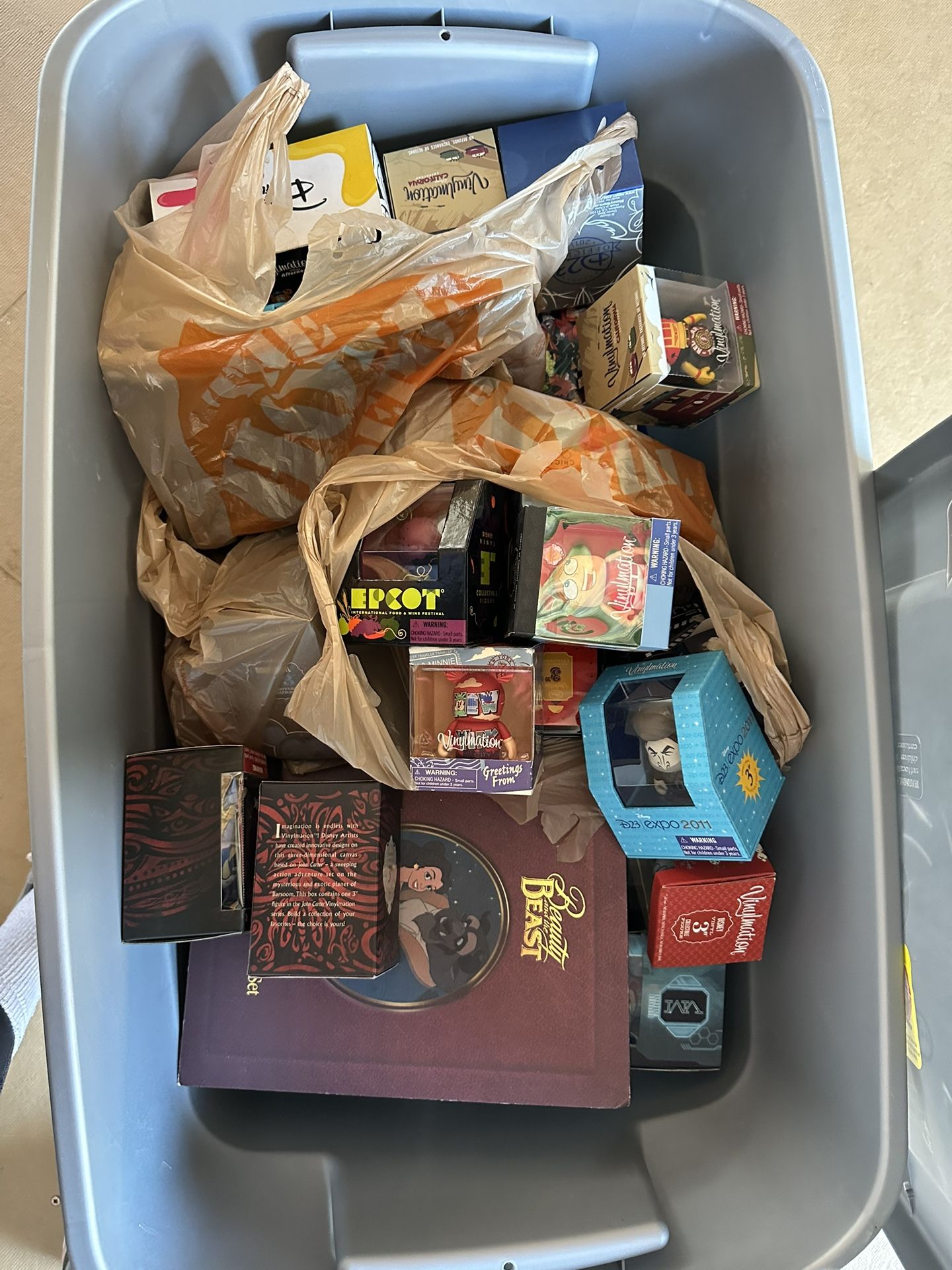 Disney - box of random Disney collectibles. 30+ Vinylmations, Beauty and the Beast ornament set NIB, lunch boxes, a puzzle, mug, cutting board, etc