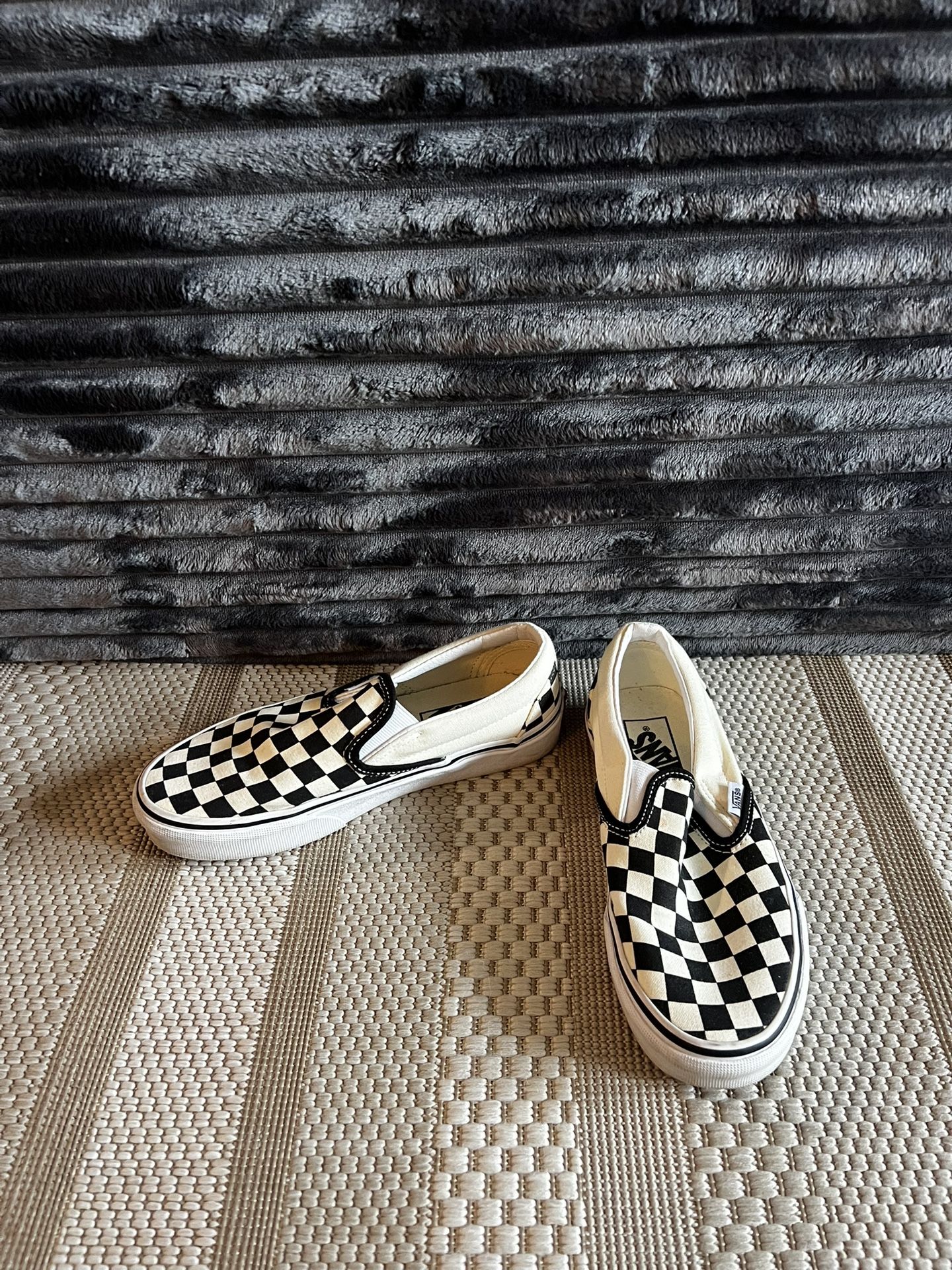 Black and white checkered Vans slip-on shoes size 5.5W