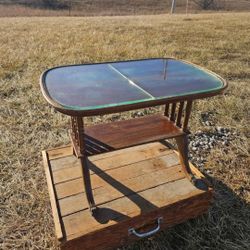vintage-style retro wooden side table featuring a glass top insert and a lower shelf & claw feet