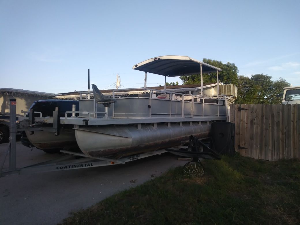 1992 24 foot Harris pontoon boat with 50 horse Johnson and trailer