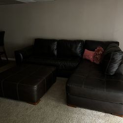 Faux Leather Couch And Oversized Ottoman 