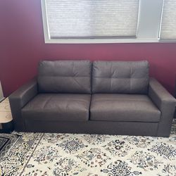 brown faux leather sleeper sofa (also known as a sofa bed) with its cushions And Mattress 