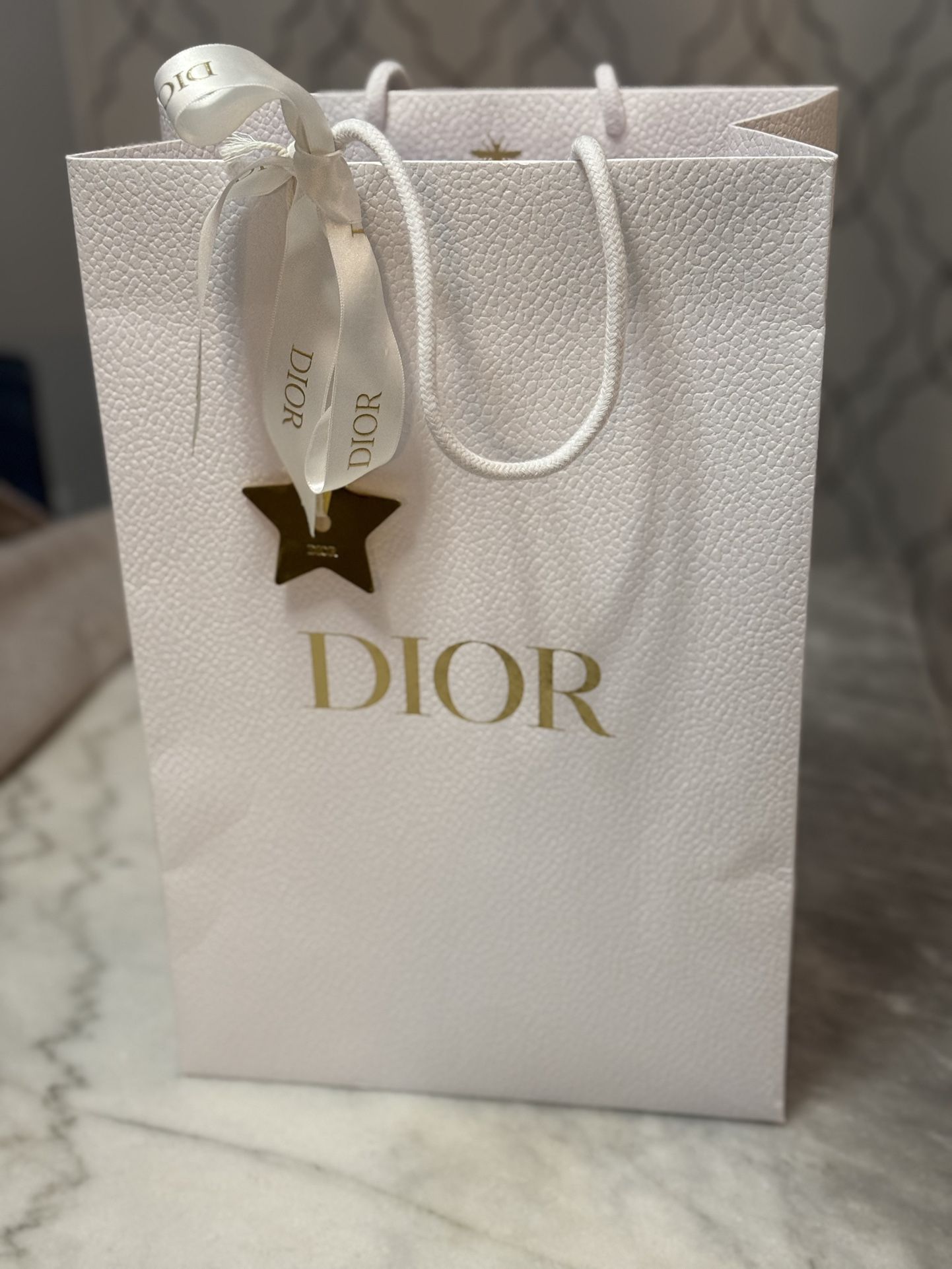 Dior empty bag with brand bow and metal golden star
