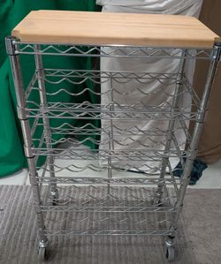 Bottle shelving unit features a solid wood, top surface and chrome plated wire shelves for holding wine bottles