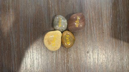 Faith, imagine, strength, and dream words on rocks