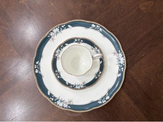 Noritake Sandhurst fine bone china salad plates, featuring a delicate floral design in teal, gold, and off-white. Cup and saucer