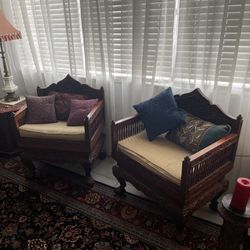 Antique set of hand-carved wooden armchairs.