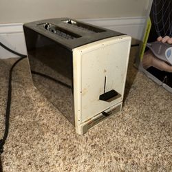 vintage Proctor-Silex 2-slice toaster features a classic chrome and white design. Has stains from age/use. Tested & works