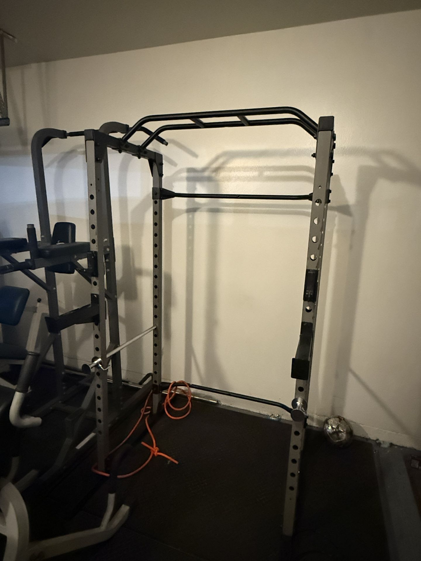 Gym Equipment; Squat Rack With Olympic Bar. Dips, Pull Ups And Abs Machine And Lower back Machine