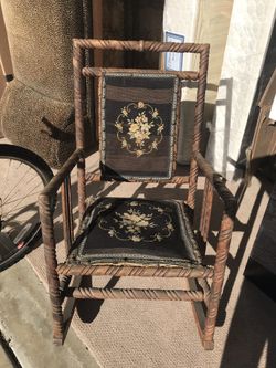 Antique rocking chair with black needlepoint