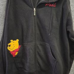 This is a black Disney Winnie the Pooh fleece zip-up hoodie. 