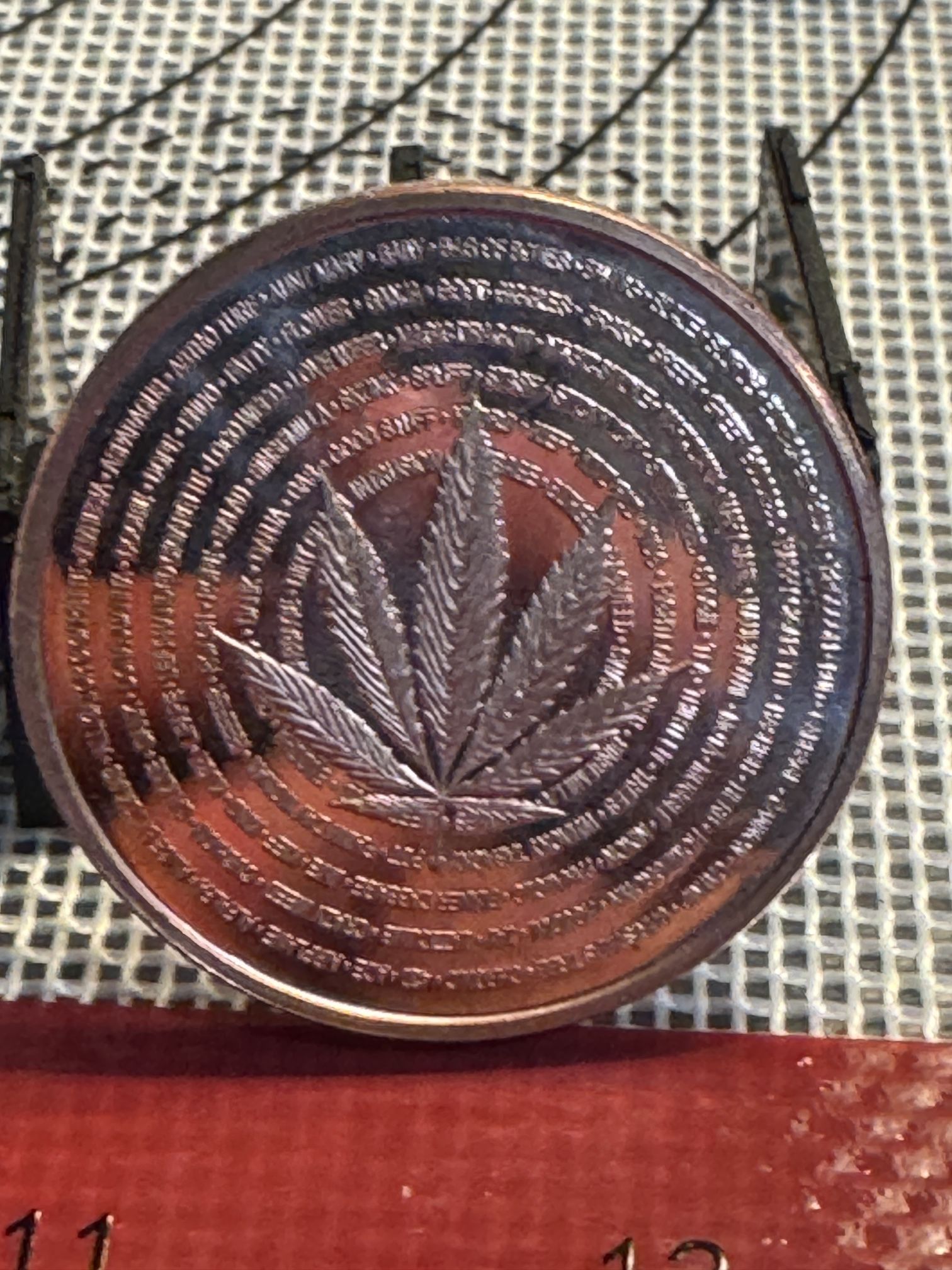 This is a modern .999 copper round featuring a cannabis leaf design.
