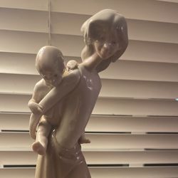 Woman Holding Child Figurine