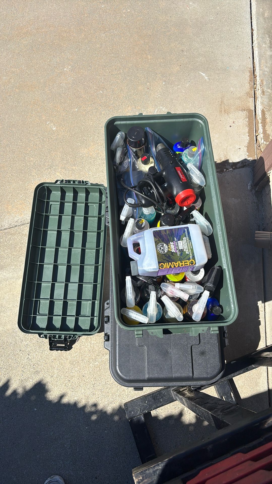 Plastic Bin With Lots Of Car Cleaning Products And Heat Gun
