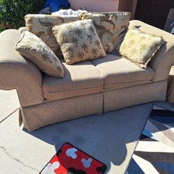Tan Oversized Loveseat With Palm Tree Pillows