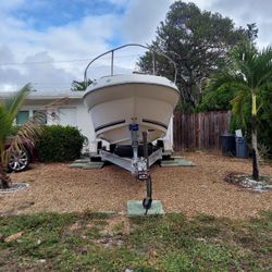 White Fiberglass Boat on Trailer