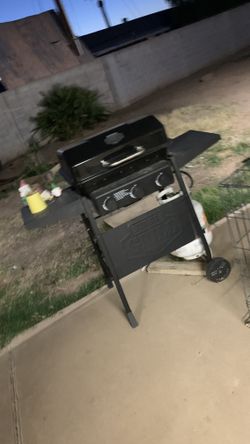 Grill with propane tank.