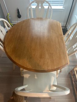 Small round dining room table with four chairs