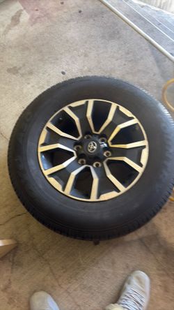 (3wheels )These are genuine Toyota Tacoma TRD Sport wheels, featuring a distinctive 6-spoke black machined finish