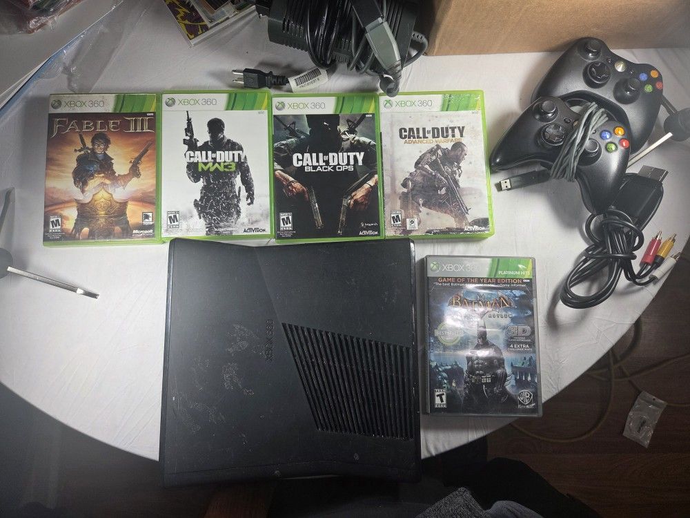 Xbox 360 with 5 games, 2 controllers, and charging cable