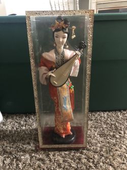 Oriental piece in Glass case.