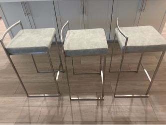 Metal bar stools with grey cushions
