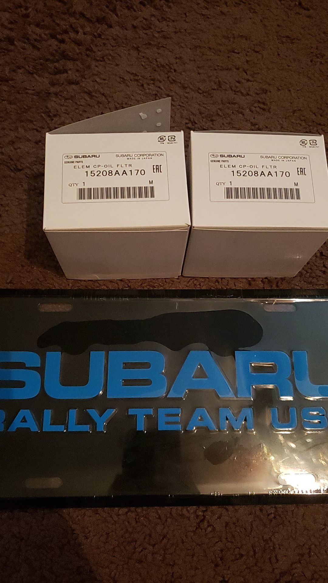 Subaru rally team vanity plate and 2 brand new Subaru oem oil filters part number 15208AA170