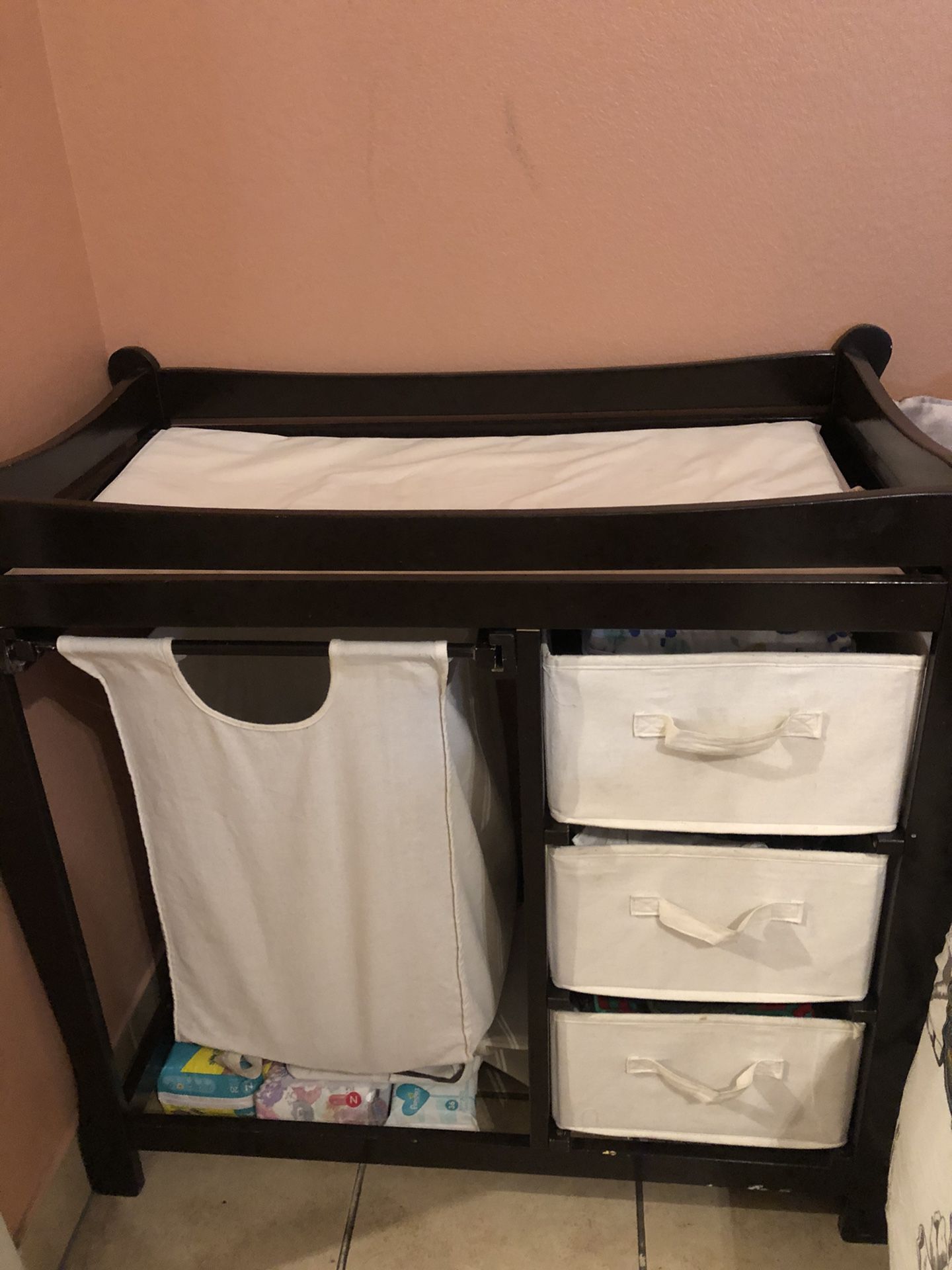 Changing table with hamper and storage