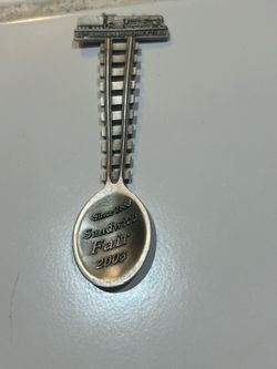 collectible pewter souvenir spoon from the Sandwich Fair in Sandwich, Illinois, featuring a train handle commemorating the event.
