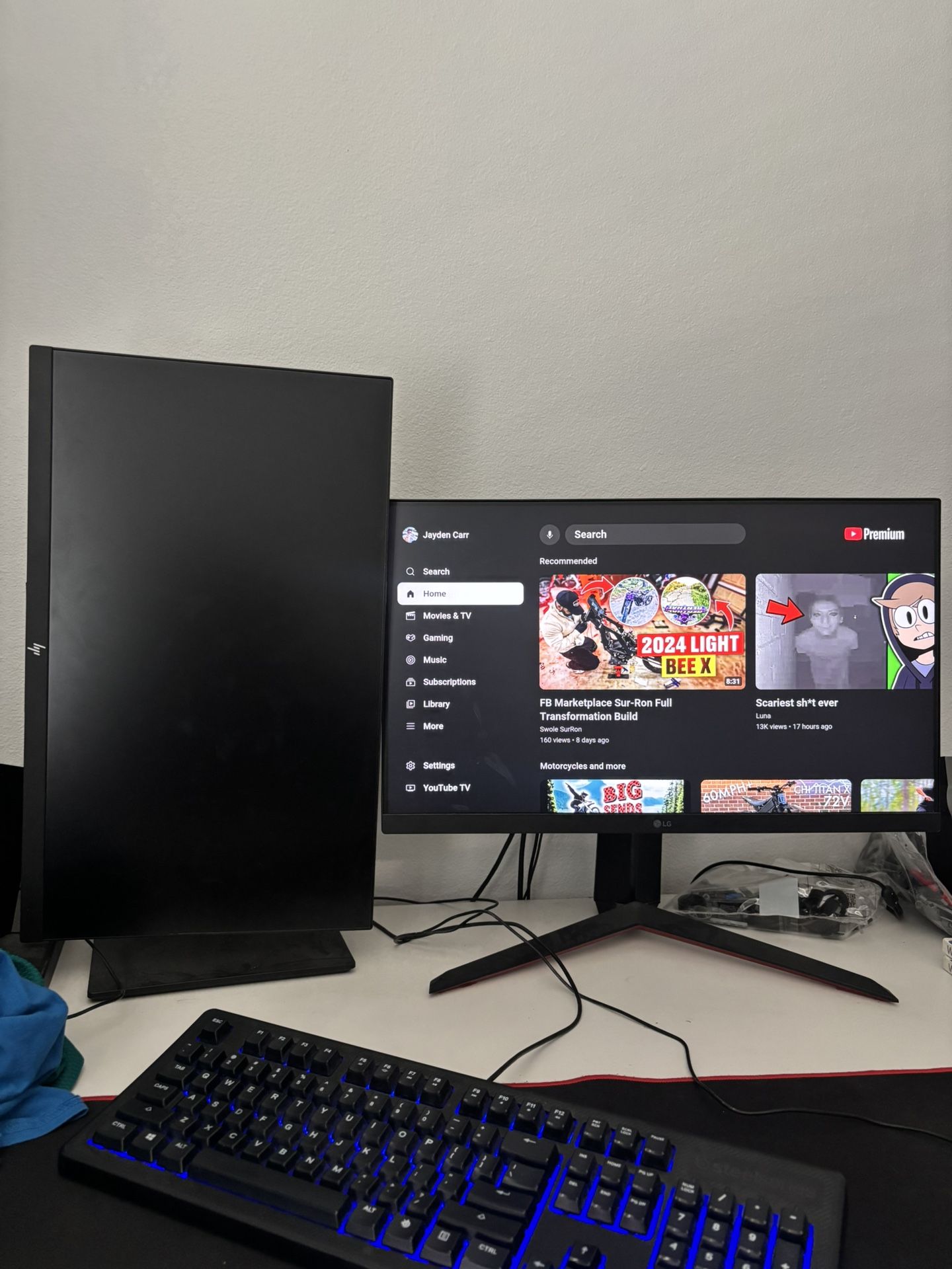 an LG monitor, an hp monitor, a ps4, a MacBook Pro, and an element 40 in tv
