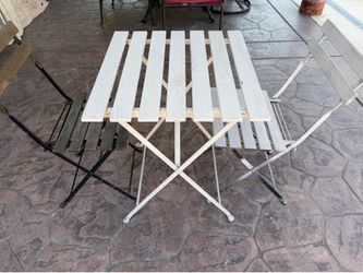 Small settee table with 2 chairs.