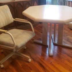 80's octagonal Dining room table with insert and 4 upholstered rolling chairs that can tilt back. 