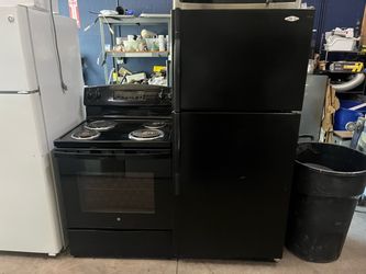 Black GE Electric Range and Whirlpool Refrigerator Set