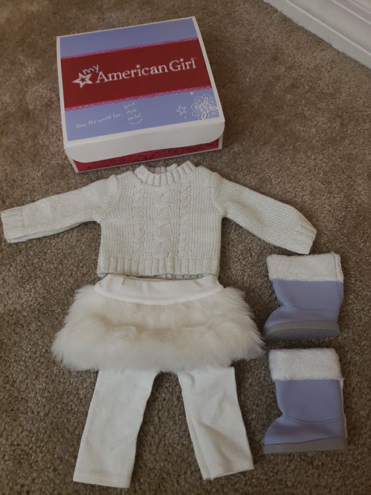 American girl soft as snow outfit in box.  Includes sweater, leggings, boots and fur skirt.  Great condition.   