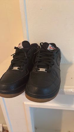 black Nike Air Force 1 sneakers with gum soles