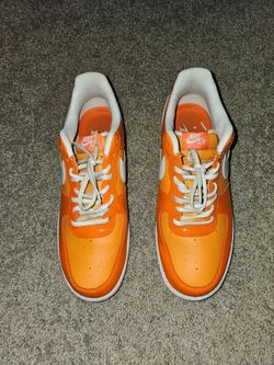 Black, red, and white Air Jordan 11 Low and Orange and white Nike Air Force 1 Low