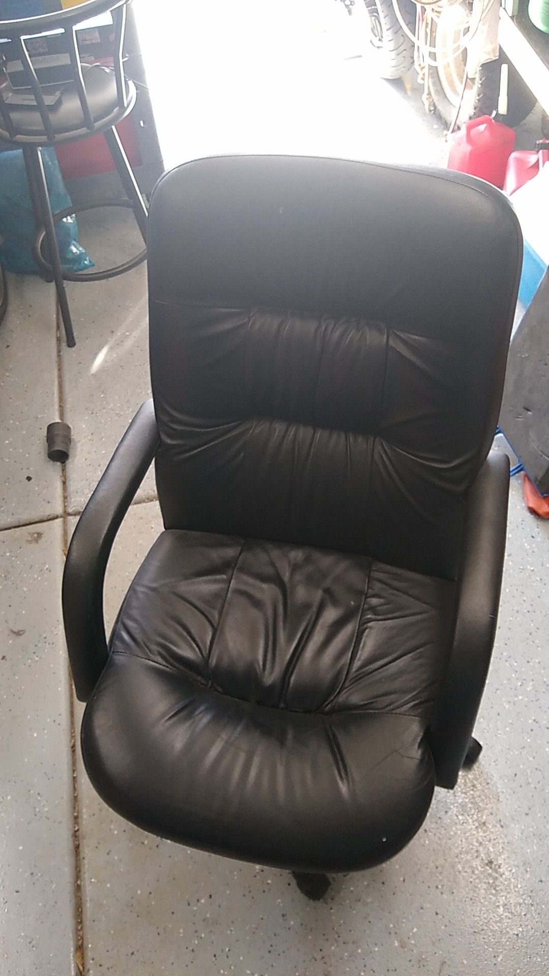Black leather office chair. Slightly worn but still in good condition