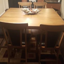 wood and black leather upholstery dining table