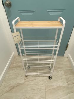 Rack ,  brand new , has 4 wheels ( 2 . 6  ft  Tall )  ( 1 . 4 ft  wide )