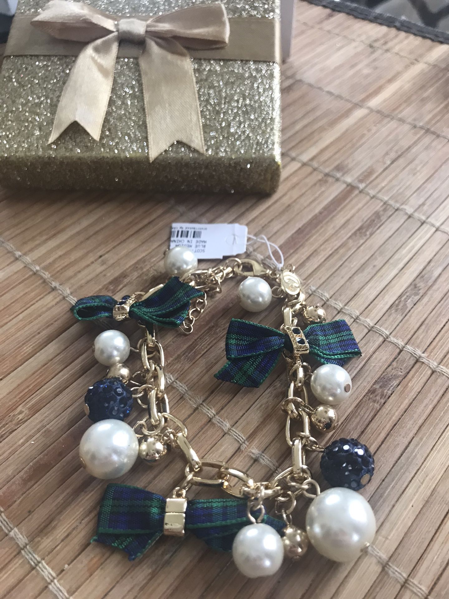 Gold tone pearl and blue/green bow ties charm bracelet