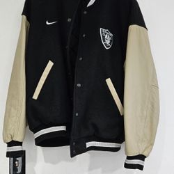  Oakland Raiders vintage Nike varsity jacket with a black wool body and beige leather sleeves Mens Size Large. 