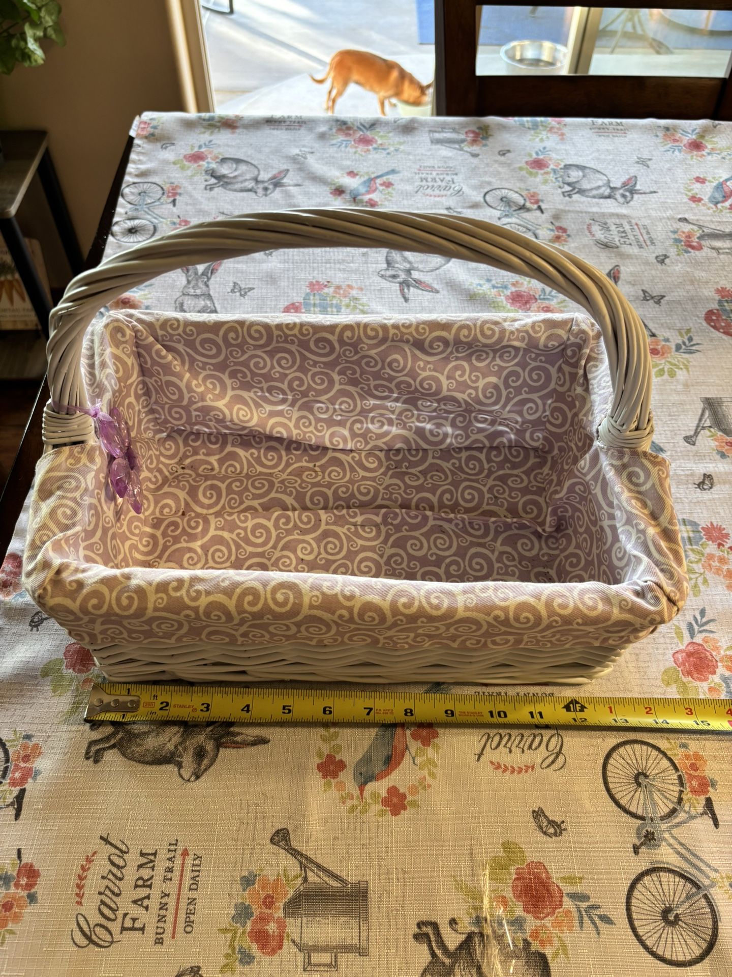 Vintage white wicker basket with a purple and white patterned fabric liner