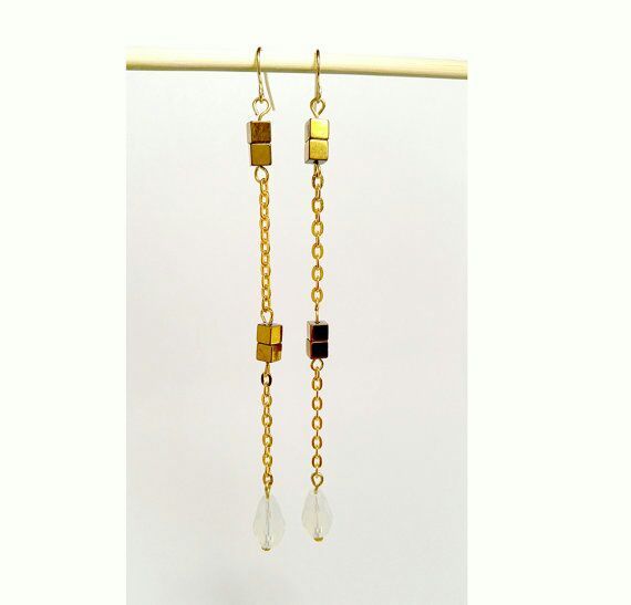 Simple and elegant long earrings with milky white tear drop crystal glass beads and golden colored cube beads