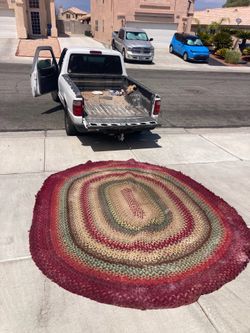 Antique braided oval rug