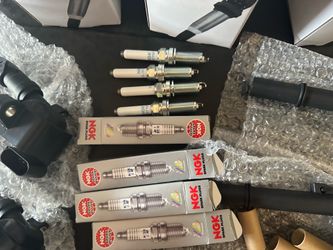 Ignition coils and spark plugs. New. Never used